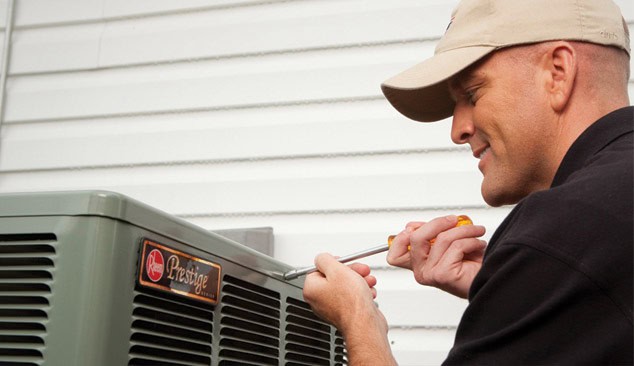 Bry Heat and Air technician servicing an air conditioner